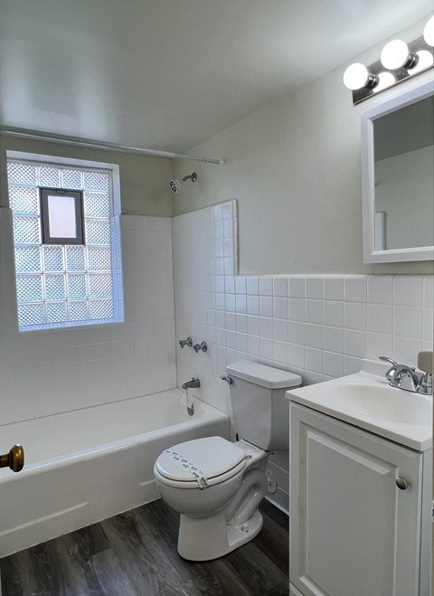 a bathroom with a toilet and a bath tub and a sink